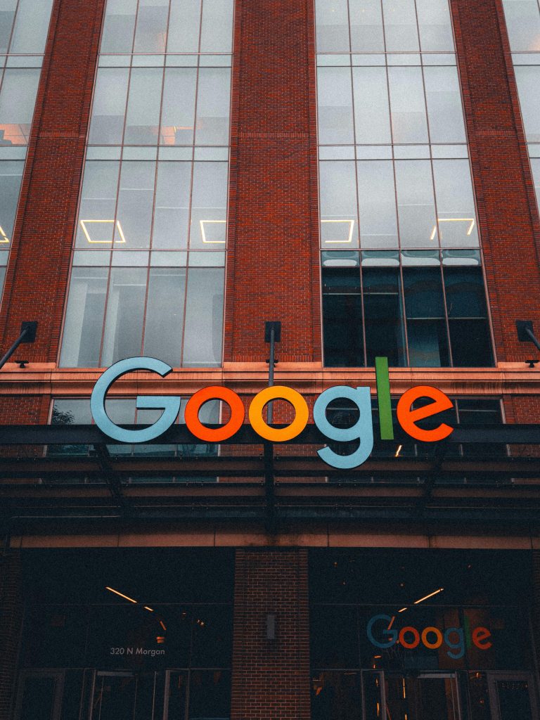 pexels-photo-29257597-29257597 Colorful Google logo on modern building exterior in urban environment.
